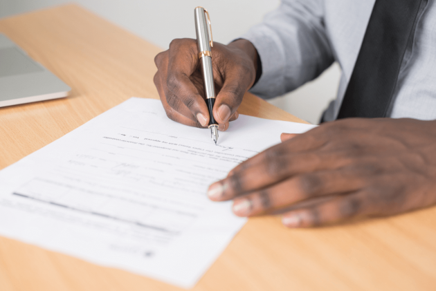 A man filling out a form.